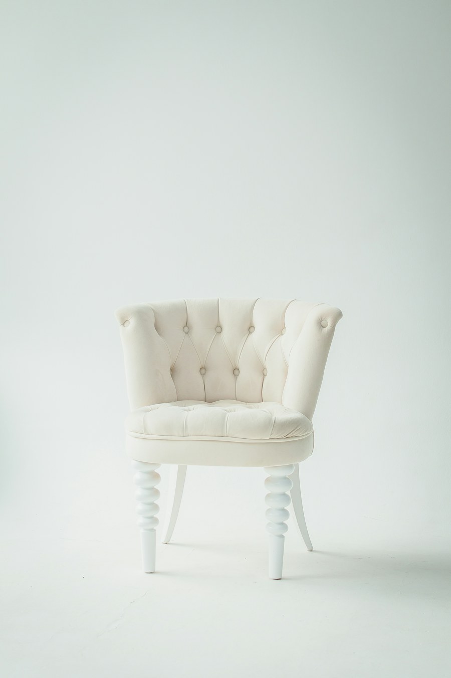 Fauteuil crème capitonné